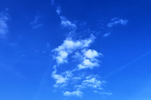 Beautiful fluffy white beautiful cloud formations in a deep blue summer sky