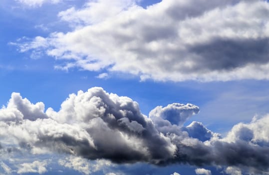 Beautiful fluffy white beautiful cloud formations in a deep blue summer sky