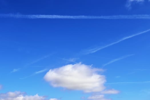 Beautiful fluffy white beautiful cloud formations in a deep blue summer sky