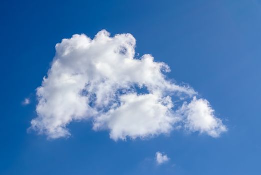 Beautiful fluffy white beautiful cloud formations in a deep blue summer sky