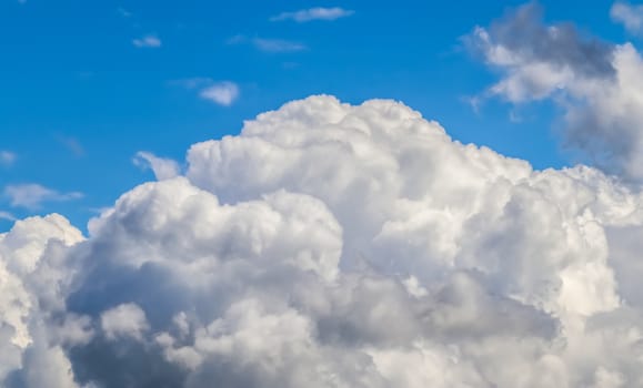 Beautiful fluffy white beautiful cloud formations in a deep blue summer sky