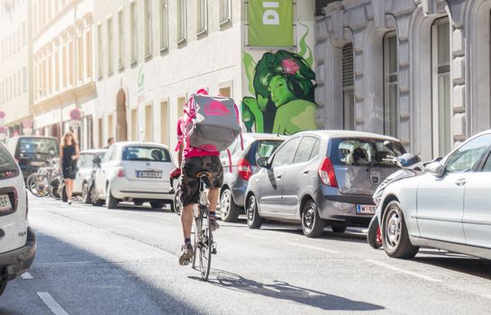 Foodora is an international food delivery service from Germany, cyclist riding with delivery box
