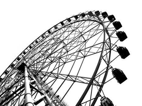 A ferris wheel at a local fun fair seen in silhouette