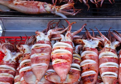An outdoor vendor sells squid hot off the grill
