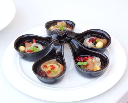 A display of Chinese herbal soup with red dates, wolfberries and lotus seeds
