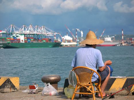 -- in the background you can see ships and cranes of Kaohsiung Harbor in Taiwan

