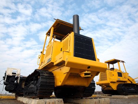 Heavy earth moving machinery is resting on concrete sleepers
