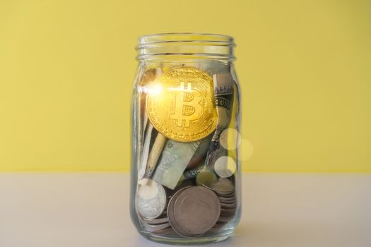 Bitcoin the jar full of coin and bank notes meaning of saving investment with cryptocurrency digital money fintech online network. Business technology concept.