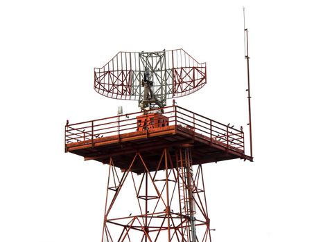 Red and white metal radar tower in airport area with plane landing