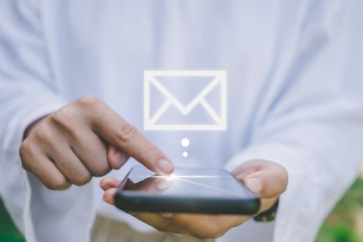 Woman hand use smartphone in public area with 1 new email alert sign icon pop up. Communication business technology concept.