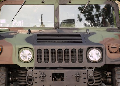 Frontal view of a heavy duty military vehicle designed for off road use

