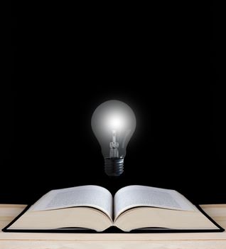 Education concept, knowledge management, light bulb and open book on chalkboard background