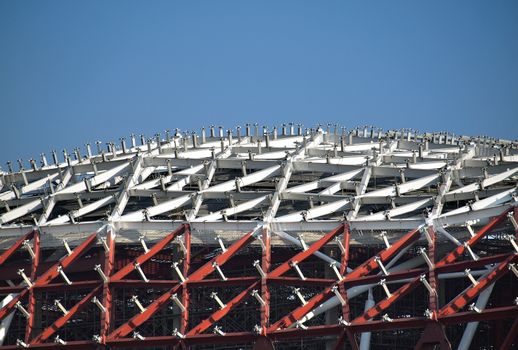 Red and white roof girders at large industrial complex
