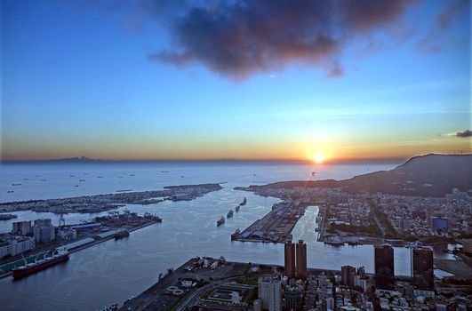 Beautiful view over the harbor district of Kaohsiung city and an ocean sunset