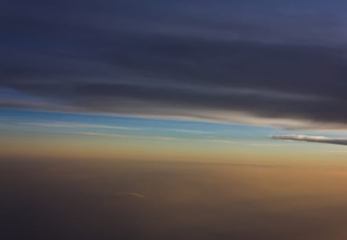 Sky and clouds at sunset bird's eye view on the plane