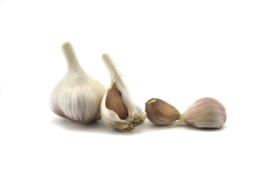Garlic bulbs and cloves in close-up isolated on white background