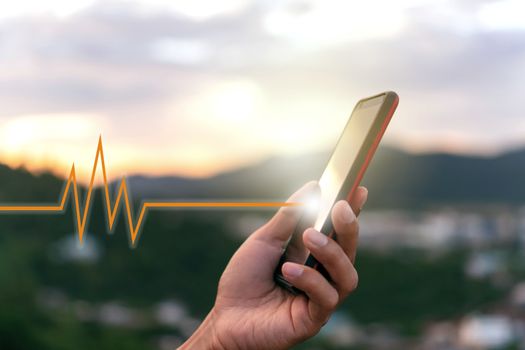 Woman hand holding smartphone with vital sign of heart beat background. Business technology health connection concept.