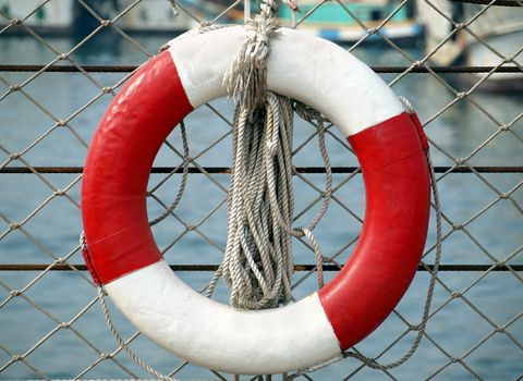 A foam core red and white life ring with a strong rope
