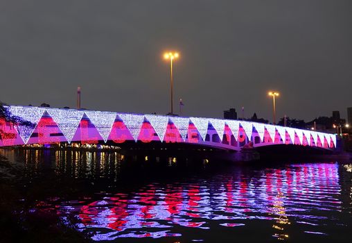 A bridge across the Love River in Kaohsiung, Taiwan, is decorated with colorful lights
