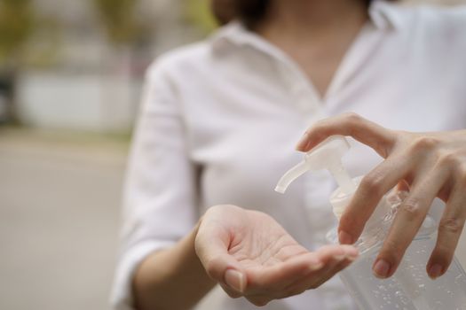 Woman washing hands with alcohol gel or sanitizer gel. corona virus or Covid-19 protection.