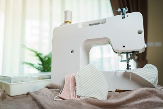 Fabrics and sewing machine for sewing an anti-virus face mask during the coronavirus pandemia.