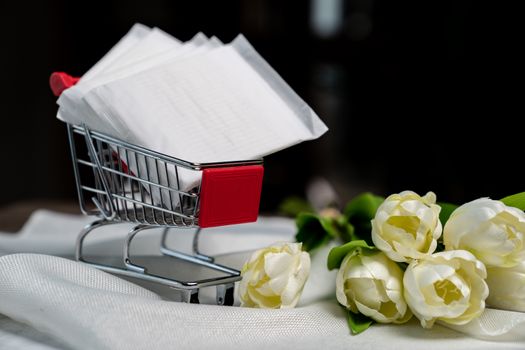 Stacked sanitary napkin pad on Shopping cart. Female pads in a shopping trolley. Menstrual period concept.