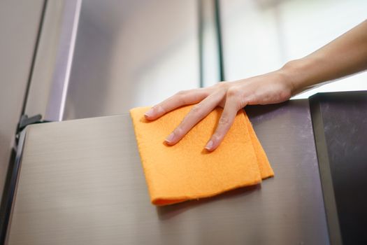 Women hands cleaning the Refrigerator at home kitchen.