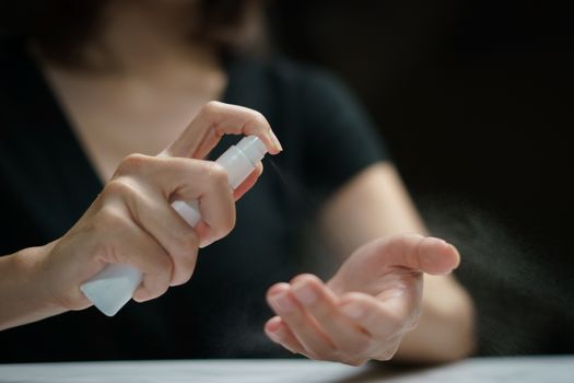 Hand applying alcohol spray for corona virus or Covid-19 protection.