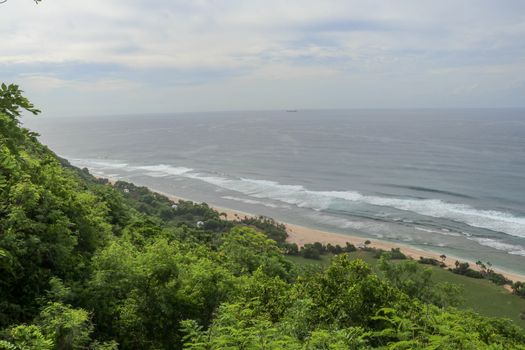 Bubble hotel at Nyang Nyang Beach on Bali Island, Indonesia. Romantic place ideal for honeymoon. A high reef off the coast of the Indian Ocean overgrown with dense tropical vegetation. Rainforest.