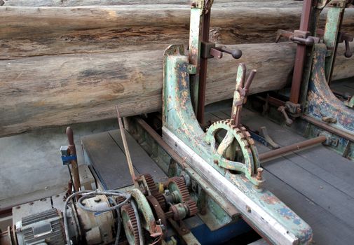 An old machine designed to process large wooden logs
