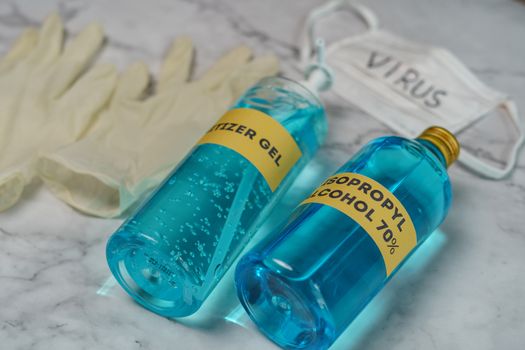surgical mask, surgical gloves, sanitizer gel, isopropyl alcohol 70% on white marble background for corona virus or Covid-19 protection.