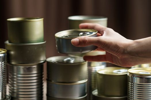 Woman hand with group of Aluminium canned food.