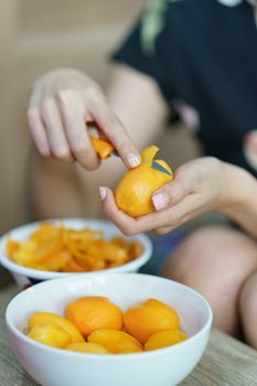 Woman peeling Marian plum or Plum Mango.