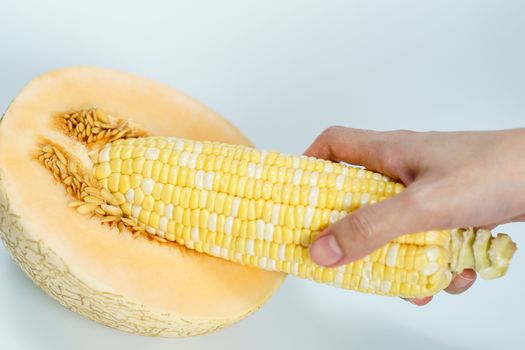 Melon and sweet corn on white background, Sex concept.