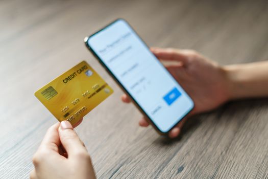 Mobile payments. hands using smartphone and credit card for online shopping.