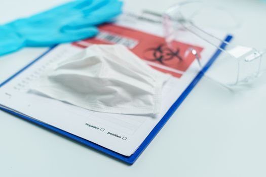 Healthcare and medicine card of coronavirus disease on clipboard with personal protection equipment.