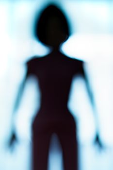 Blurred silhouette of human body look like alien.