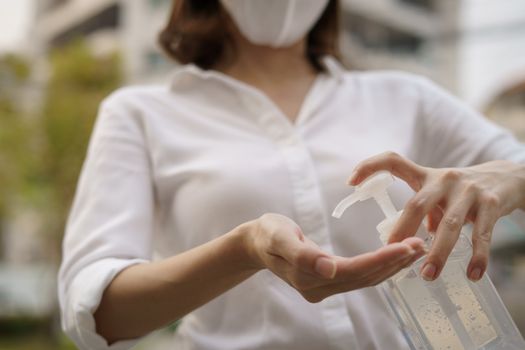 Woman washing hands with alcohol gel or sanitizer gel. corona virus or Covid-19 protection.