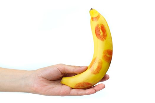 Banana with red lipstick marks with hand on white background. isolated , Sex concept.