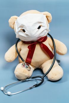 Teddy bear wearing mask and stethoscope. Coronavirus covid-19 and protection concept.