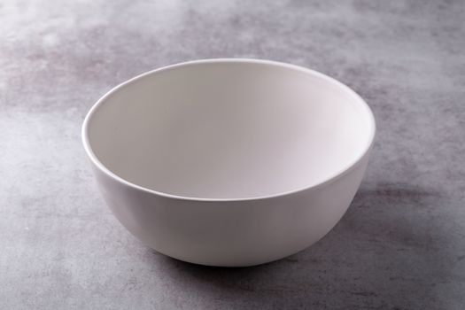 Empty blank white ceramic Bowl on Cement Board.