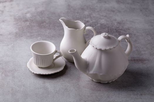 Teapot creamer, Cup and saucer on Cement Board.