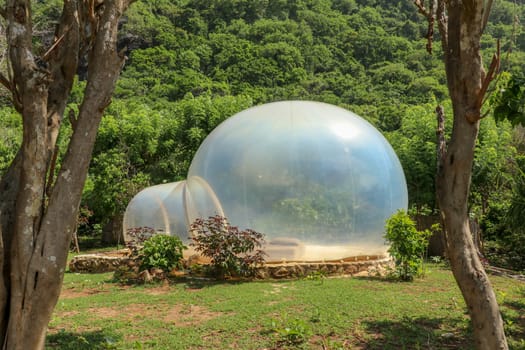 Romantic bubble house with transparent walls. Abstract sci-fi inflatable bubble. Atypical accommodation in exotic tourist destination. Tourist attraction in tropical paradise on Bali island, Indonesia