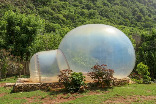 Romantic bubble house with transparent walls. Abstract sci-fi inflatable bubble. Atypical accommodation in exotic tourist destination. Tourist attraction in tropical paradise on Bali island, Indonesia