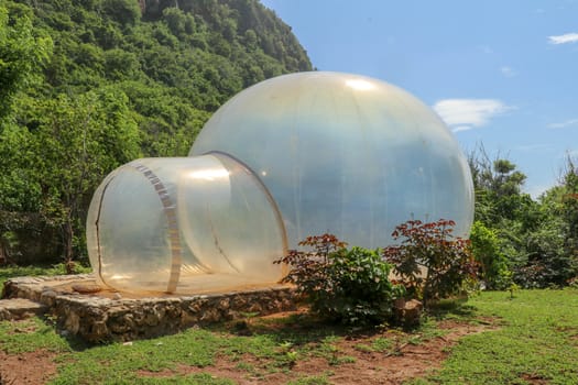 Romantic bubble house with transparent walls. Abstract sci-fi inflatable bubble. Atypical accommodation in exotic tourist destination. Tourist attraction in tropical paradise on Bali island, Indonesia