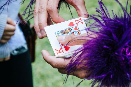 Joker with a king of hearts in his hand ready for the game