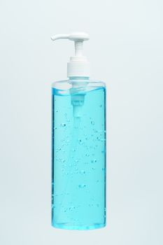 Clear blue hand sanitizer in a clear pump bottle on a white background.