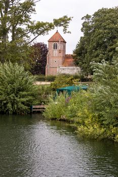 View from the River Thames of the church of St Margaret at Mapledurham in Oxfordshire near Reading.