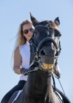  riding girl are training her black horse