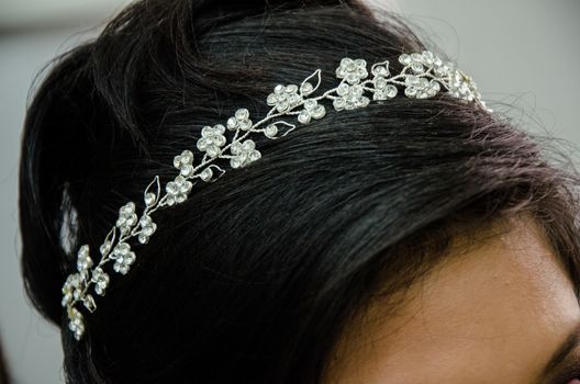 Hairstyle of a bride finished with the placement of the tiara